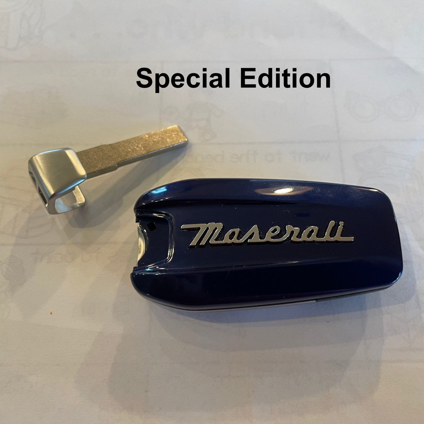 Maserati car mirror cover with metallic arm on a white background, labeled 'Special Edition'.