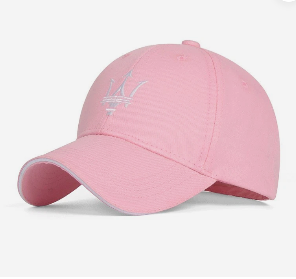 A light pink baseball cap featuring an embroidered silver Maserati trident logo on the front, displayed against a clean white background.