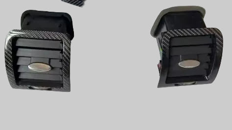 Carbon fiber patterned car AC vents on a white background