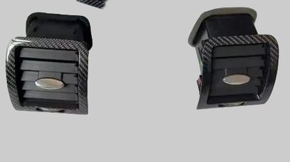 Carbon fiber patterned car AC vents on a white background