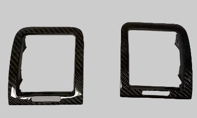 Two carbon fiber ring-shaped objects on a gray background