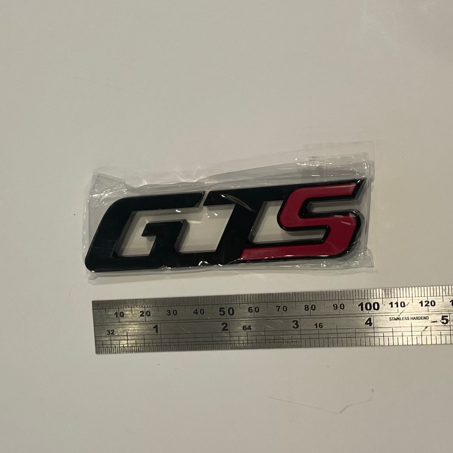 GTS logo with a ruler for scale on a white background