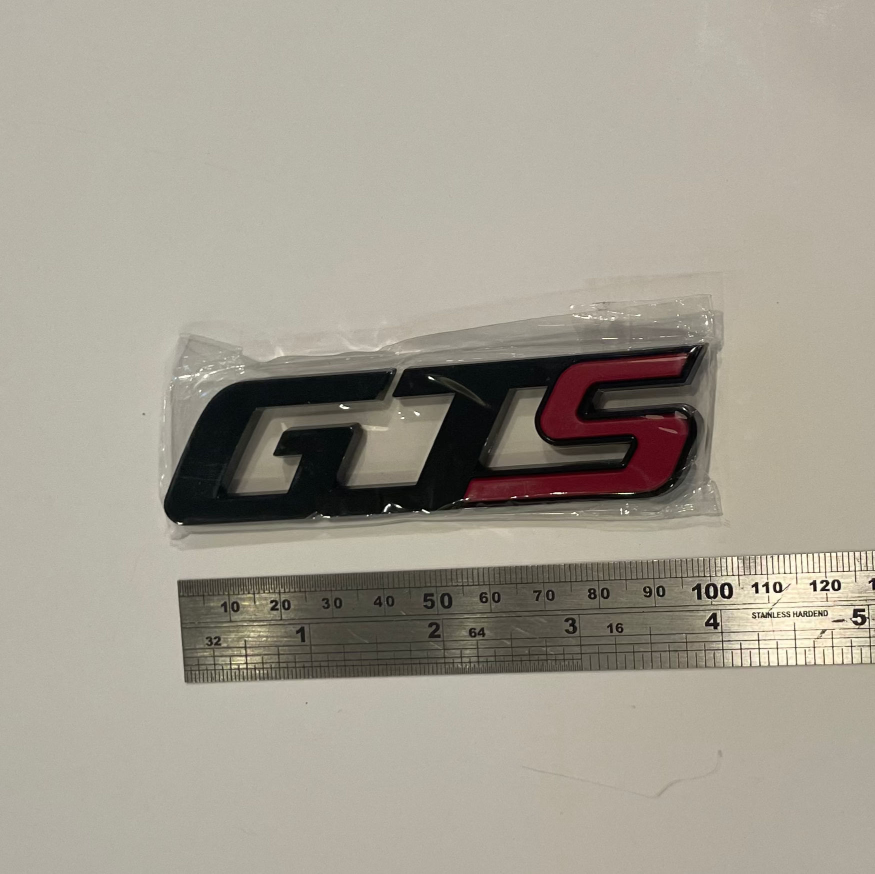 GTS logo with a ruler for scale on a white background