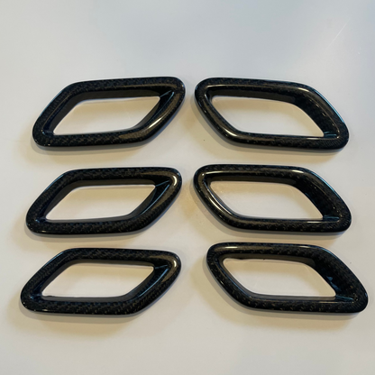 Six black rectangular plastic parts on a white background