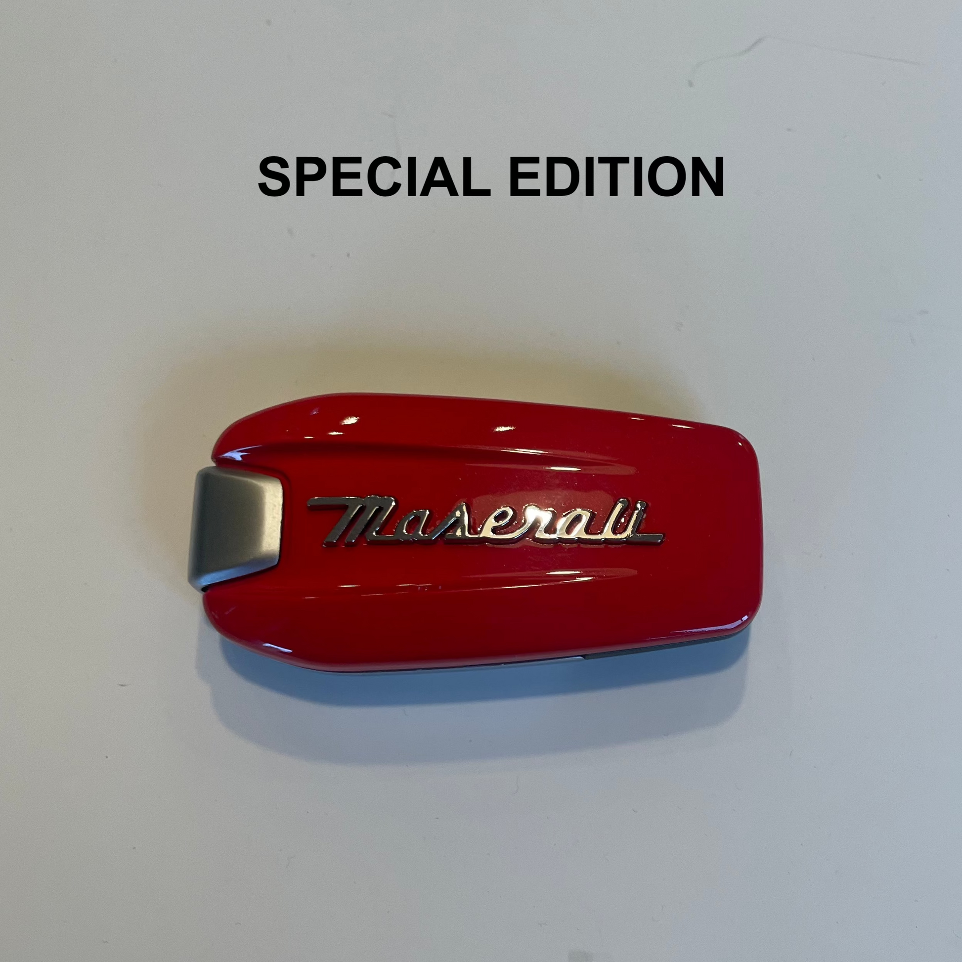 Red Maserati emblem on a white background with 'SPECIAL EDITION' text.