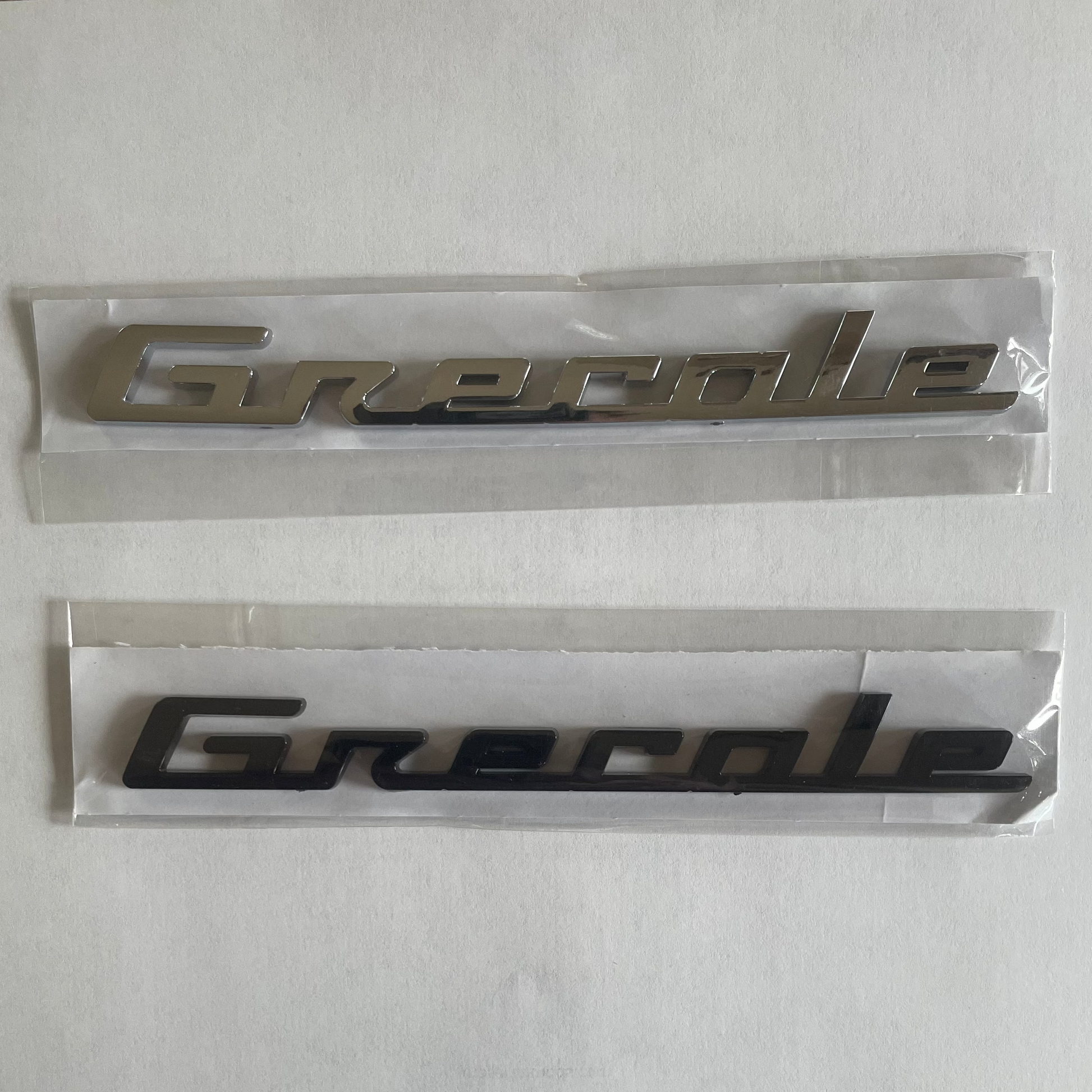 Two 'Grenade' emblems on a white background