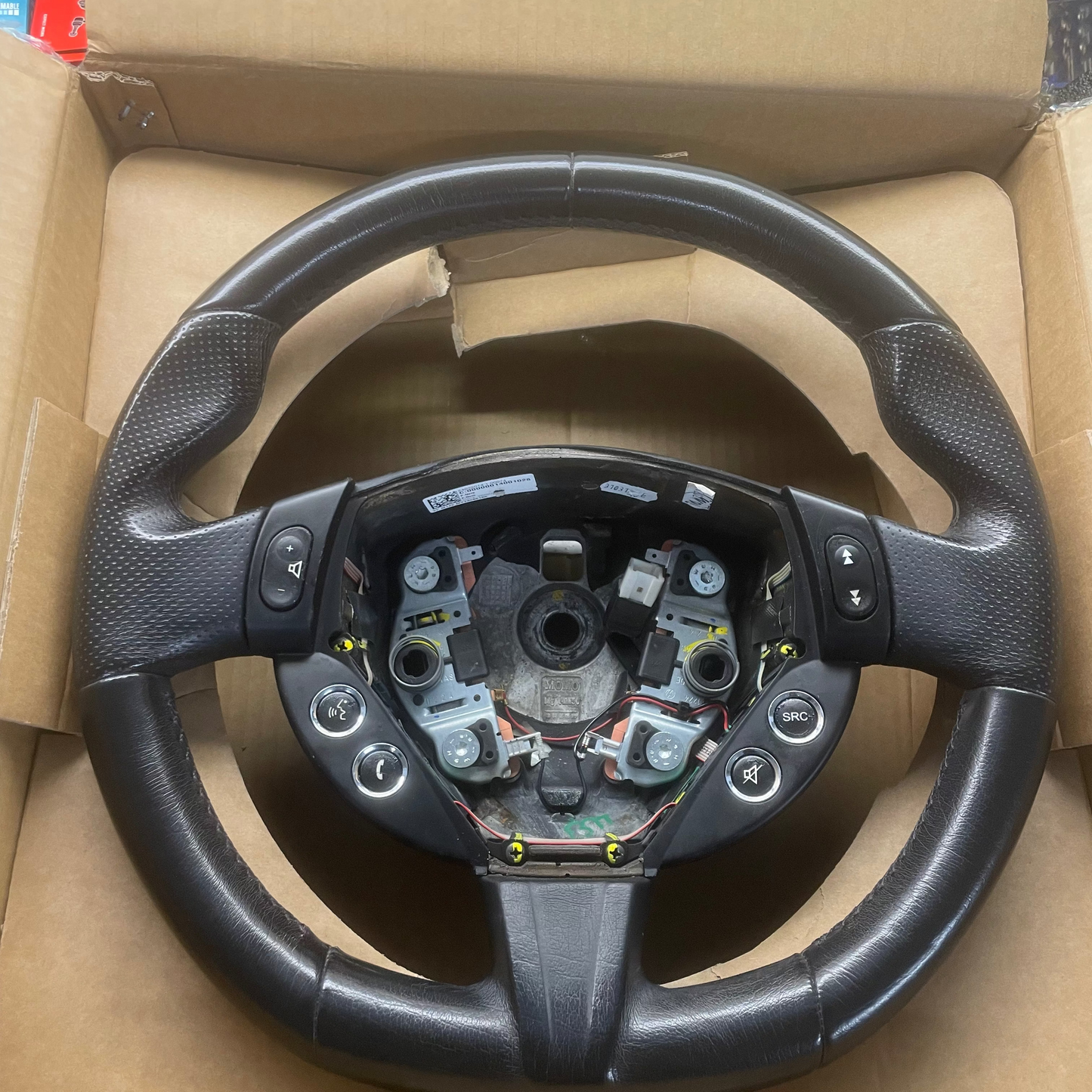 Steering wheel in an open cardboard box