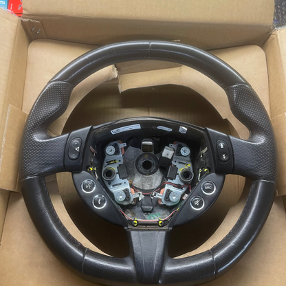 Steering wheel in an open cardboard box