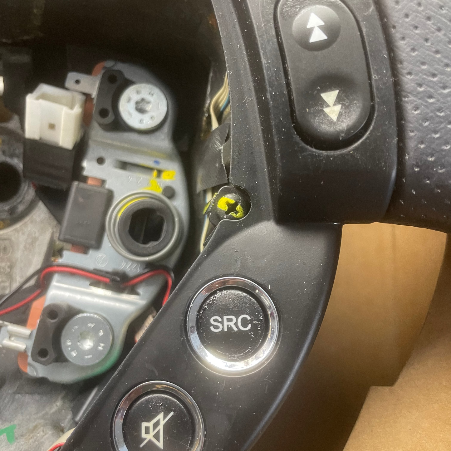 Close-up of a car steering wheel with control buttons on a blurred background