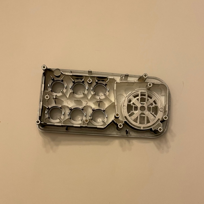 Metal engine block on a beige background