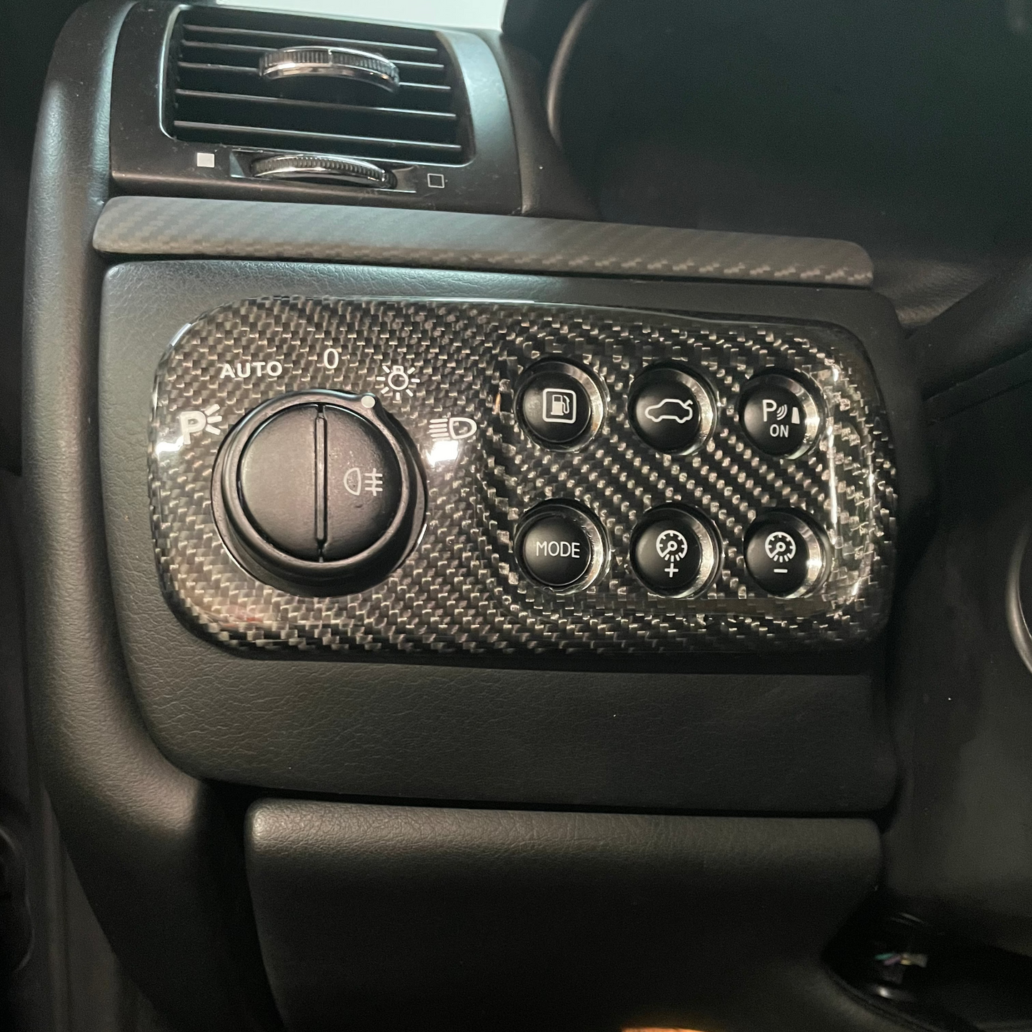 Car interior with carbon fiber patterned control panel