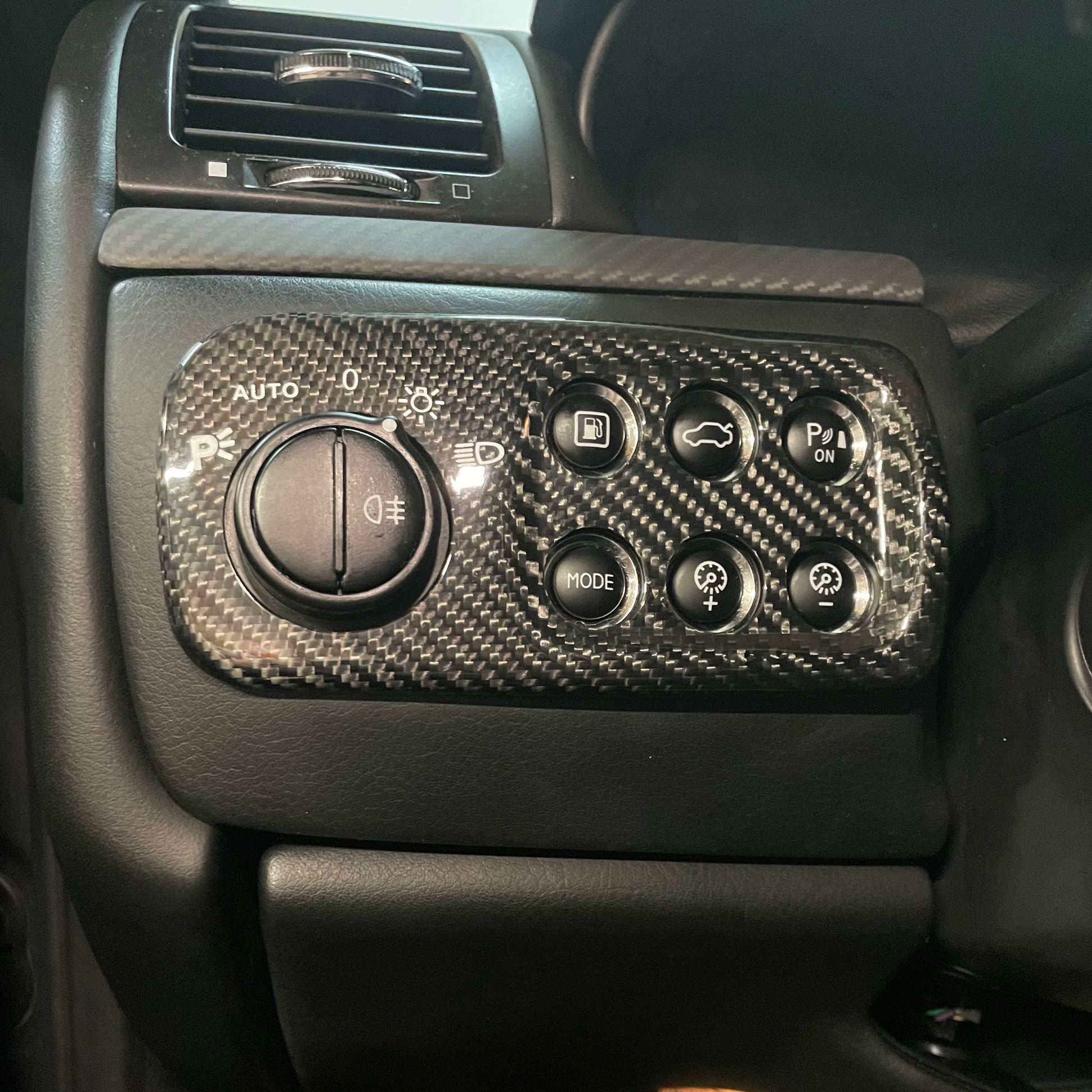 Car interior with carbon fiber patterned control panel