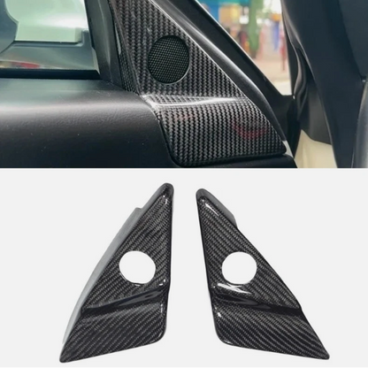 Carbon fiber car interior trim panel with a close-up of two triangular carbon fiber covers on a white background.